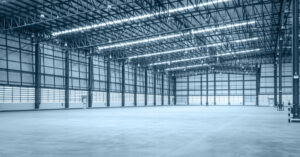 brightly lit empty warehouse with multiple bays