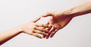 Two hands reaching out to one another