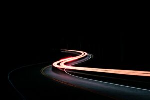 Time lapse of a car's tail lights on a winding road