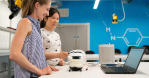 two students working on a computer