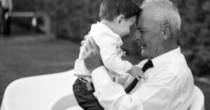 elderly man holding a young boy