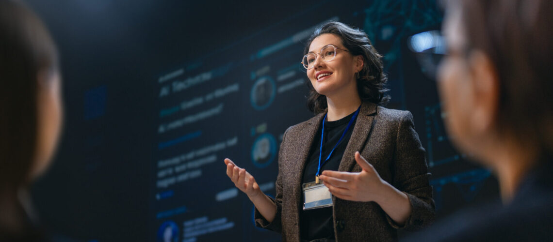 A charismatic businesswoman delivers a dynamic and engaging presentation on technology in a modern conference room, inspiring her audience with leadership and knowledge. The atmosphere is professional, empowering, and filled with anticipation for groundbreaking ideas.