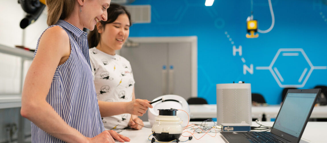 two students working on a computer