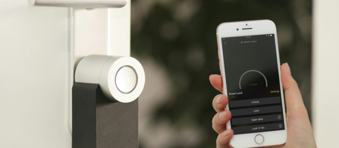 hand holding a cell phone up to a security camera