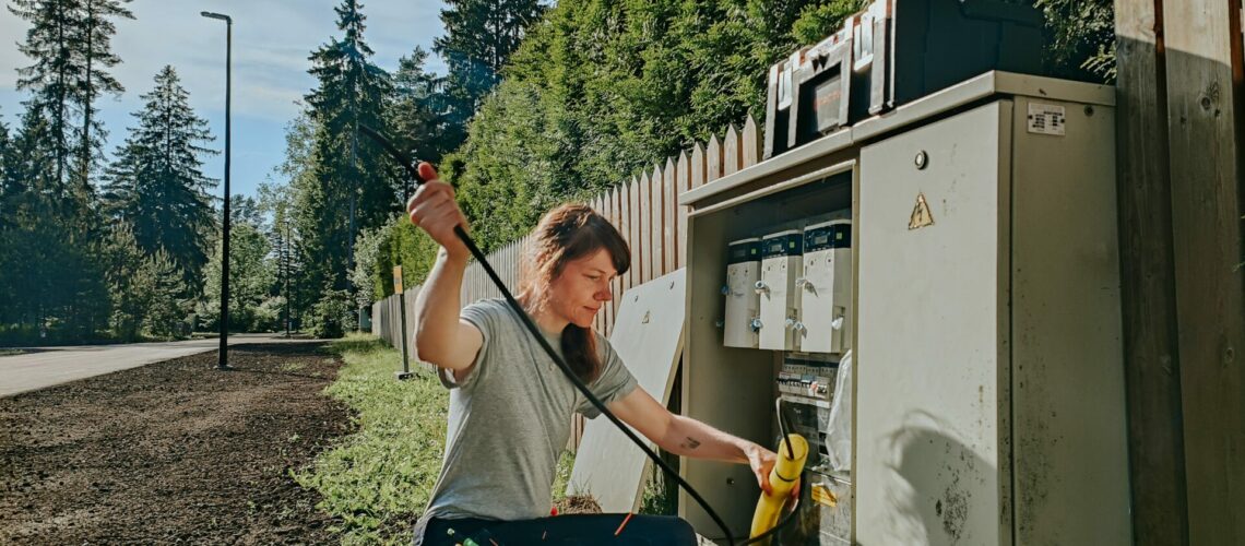 Electrician working in the field at an electrical box